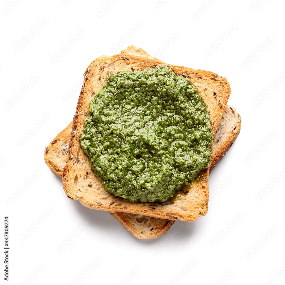 Tasty toast with pesto sauce on white background