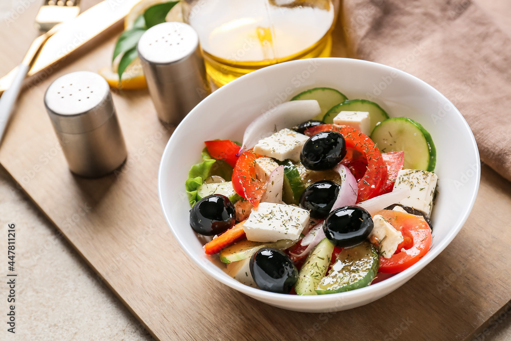 Bowl with tasty Greek salad on table