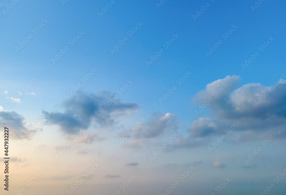 Looking up at the blue sky and white clouds background