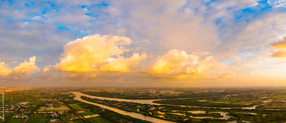 Aerial view of beautiful clouds and sun at sunset.