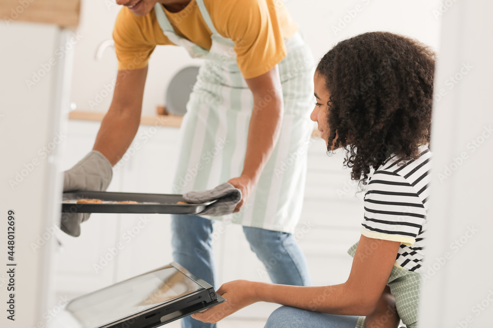 African-American brother and sister baking cookies at home