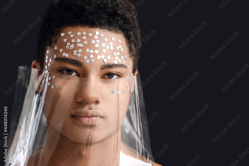 Creative portrait of handsome African-American guy on dark background