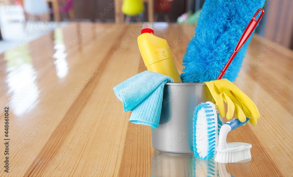 Plastic bottles, cleaning sponges and gloves in bucket