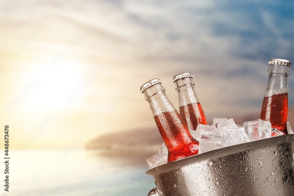 Bottles of cold and fresh beer with ice in a bucket