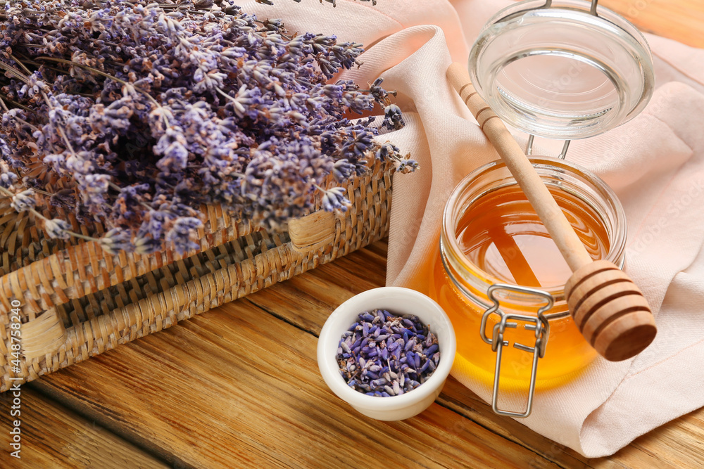 Composition with lavender flowers and honey on wooden background, closeup