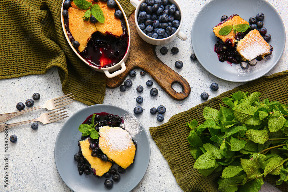 Composition with blueberry cobbler and mint on light background