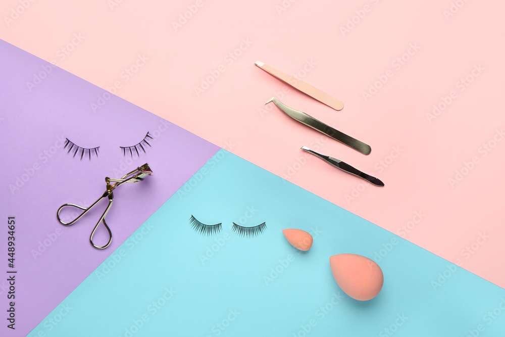 Composition with false eyelashes and tools on color background