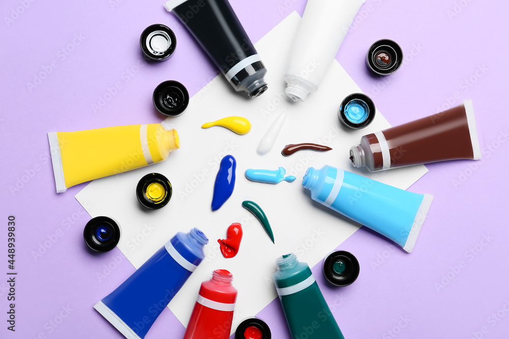 Tubes with paints on color background