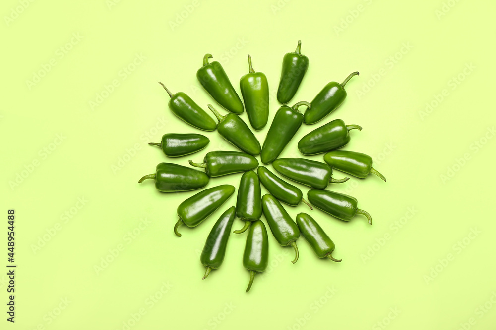 Green jalapeno peppers on color background