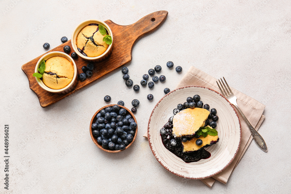 Composition with blueberry cobbler on light background