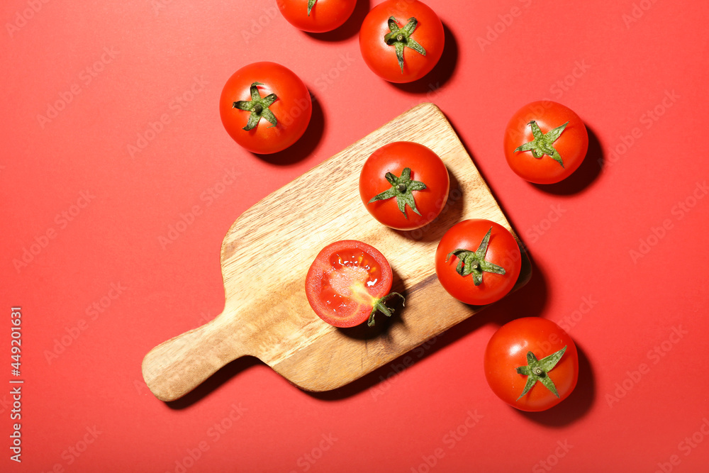 Board with fresh ripe tomatoes on color background