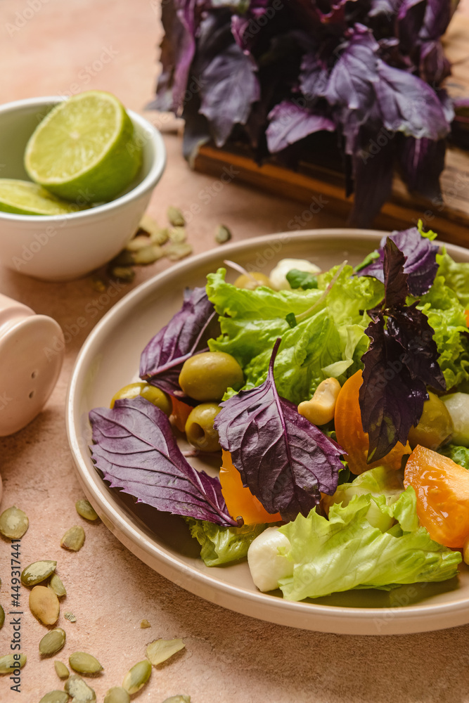 Plate with tasty fresh salad on color background, closeup