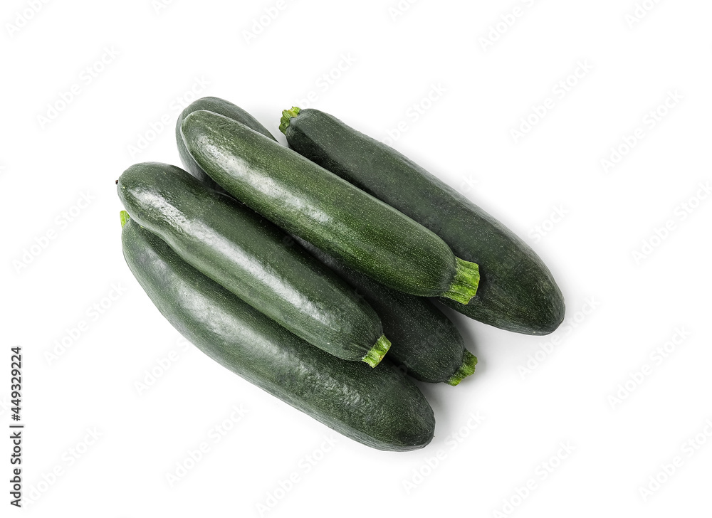 Fresh zucchini squashes on white background