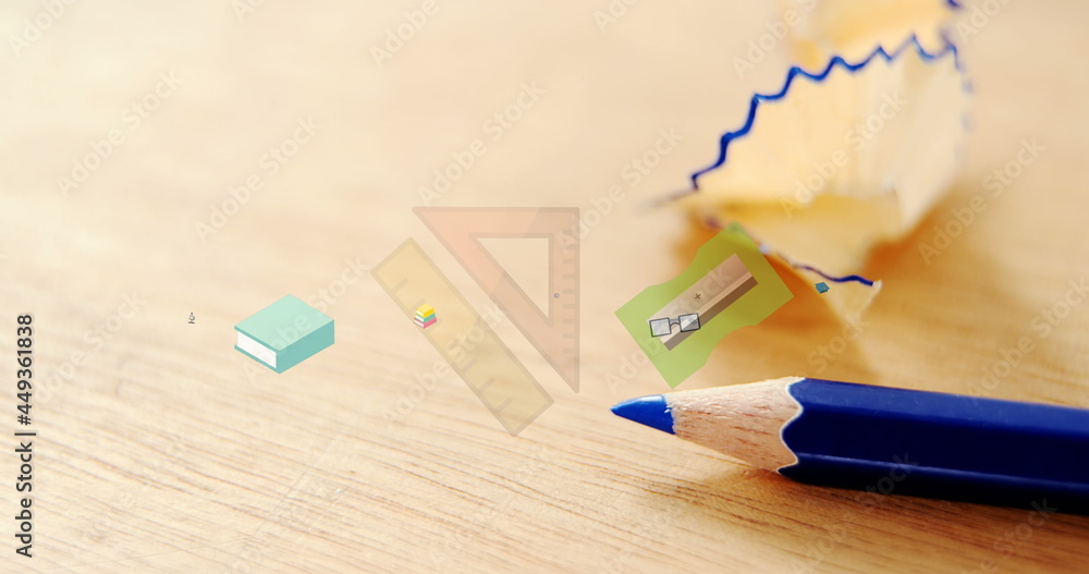 Image of school items icons over desk