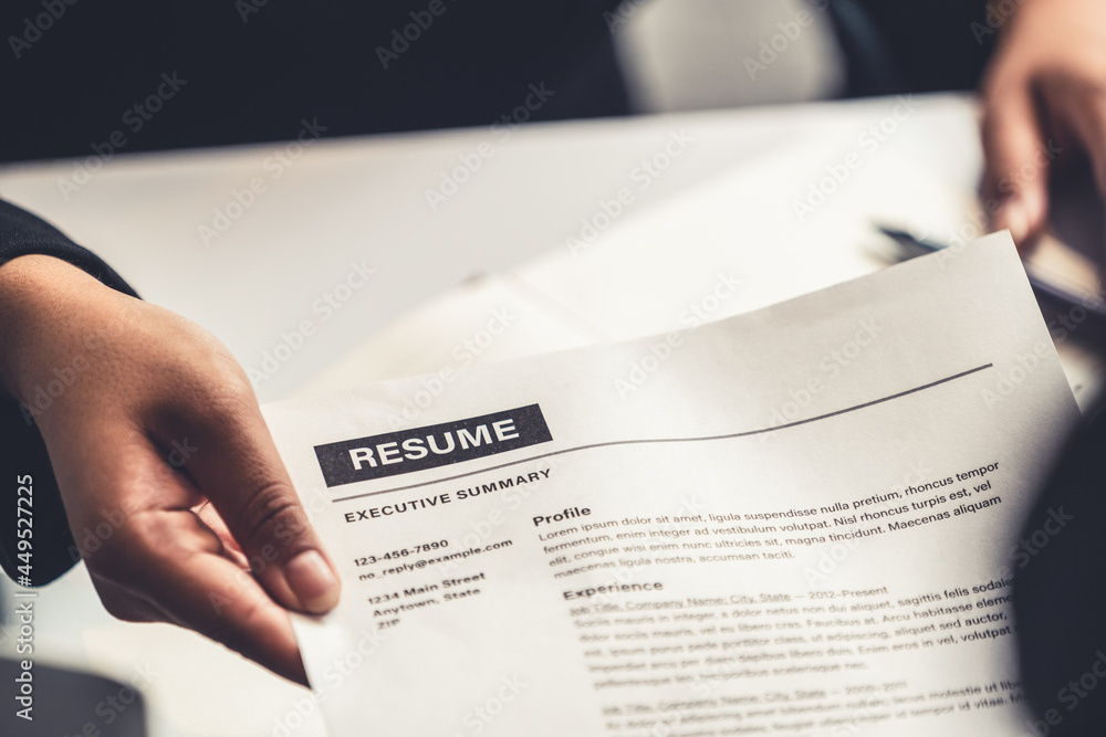 Close up view of employee candidate hands CV resume document to the interviewer HR human resources d