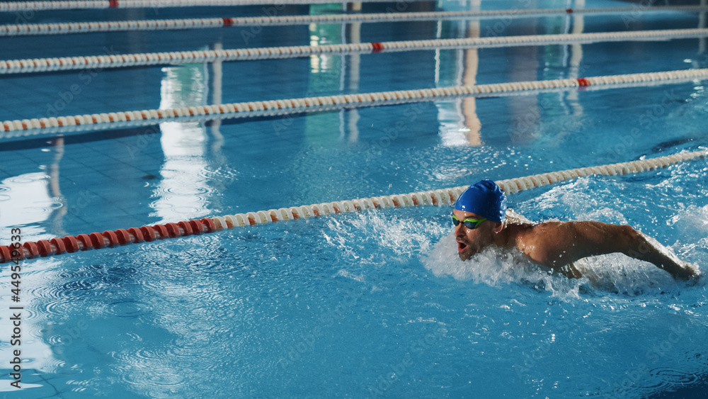 Successful Male Swimmer Racing, Swimming in Olympic Swimming Pool. Professional Athlete Determined t