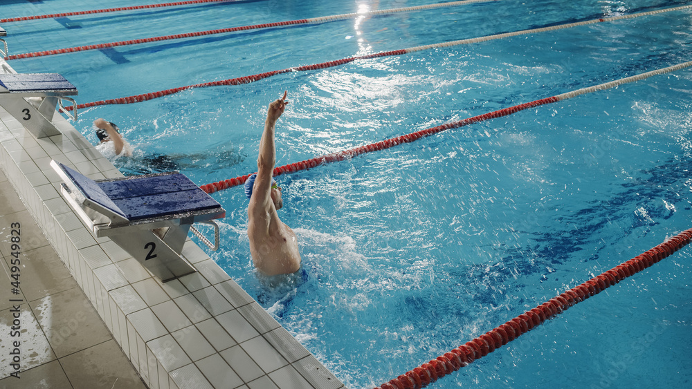 Successful Male Swimmer Celebrates New World Record and Championship Win with Raised Hand and Jumpin