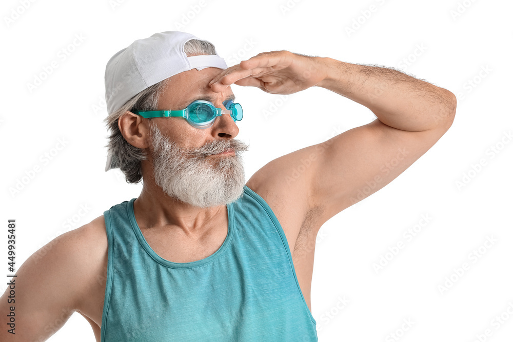 Handsome mature man with swimming goggles on white background