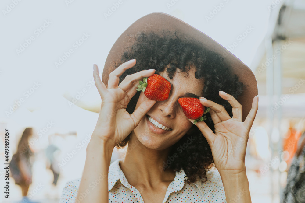 Woman having fun with strawberries