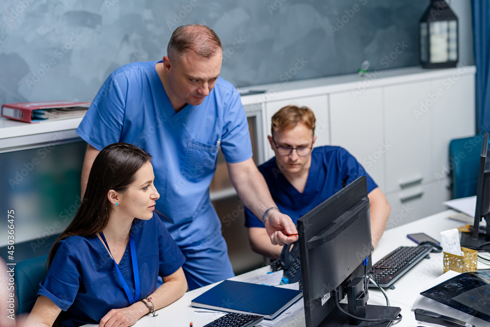 Medical team posing over medical office background while working with concentration. Professional do