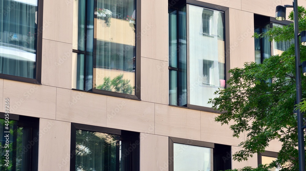 Modern glass office building with green leaves. Eco building  and greens  plants  in city concept.