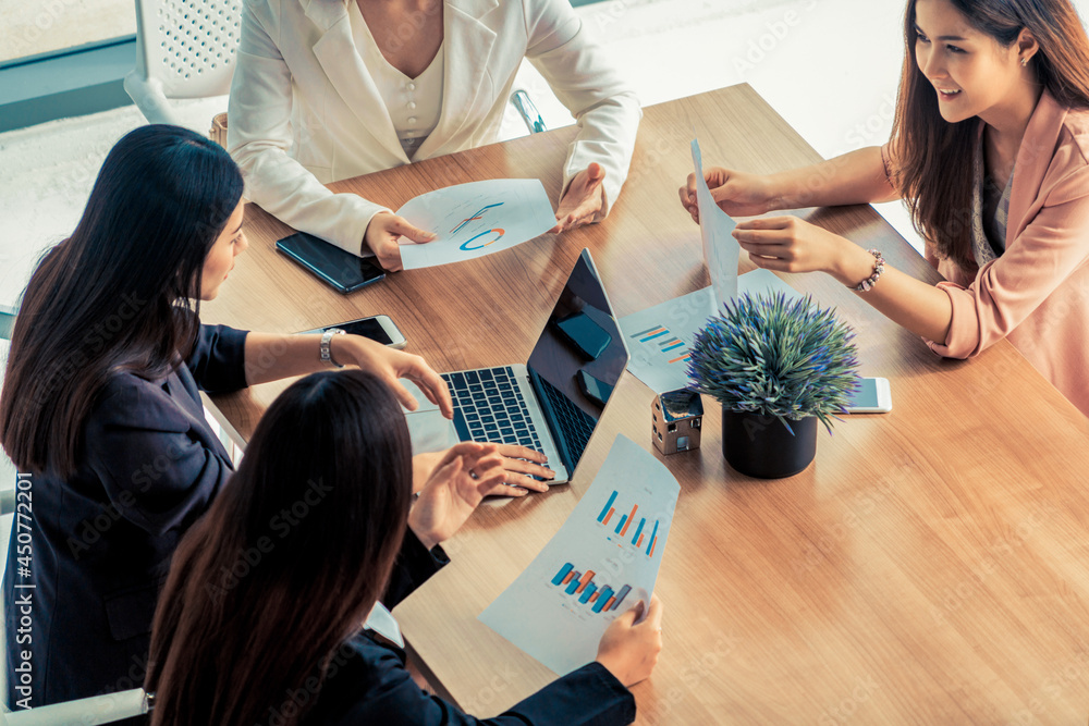 Businesswoman in group meeting discussion with other businesswomen colleagues in modern workplace of