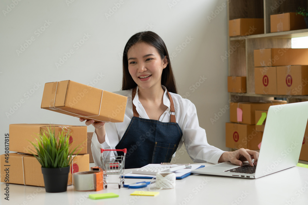 Startup small business entrepreneur SME, young asian woman working with laptop computer and delivery