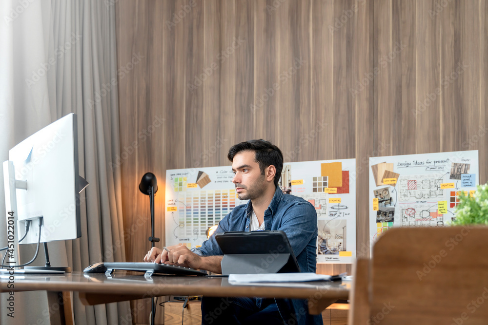 smart adult caucasian designer with beard sitting on working table desk video conference with client