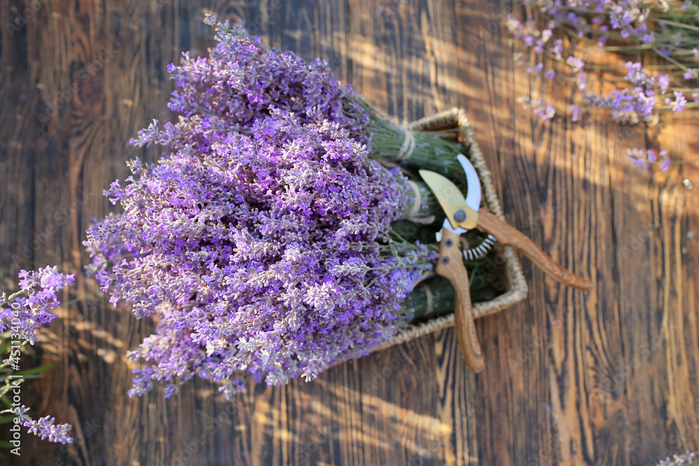 Box with lavender flowers and gardening pruner in field