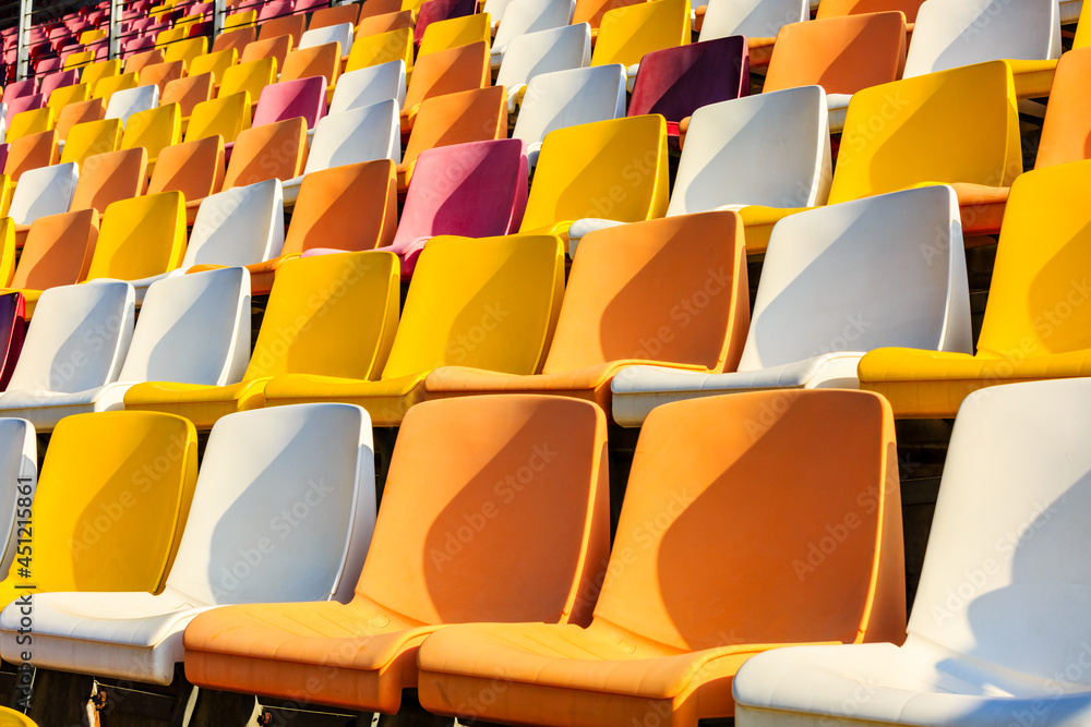 Empty plastic chairs in the stadium.