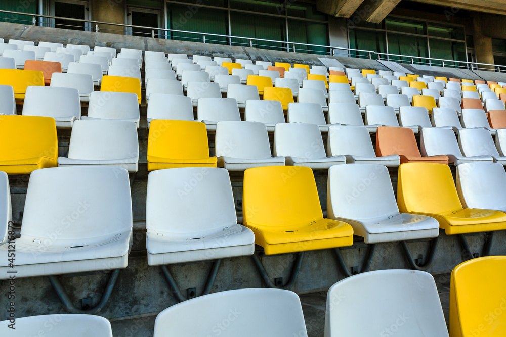 Empty plastic chairs in the stadium.