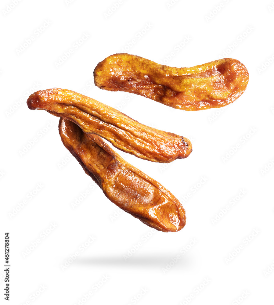 Dried bananas close up in the air on a white background