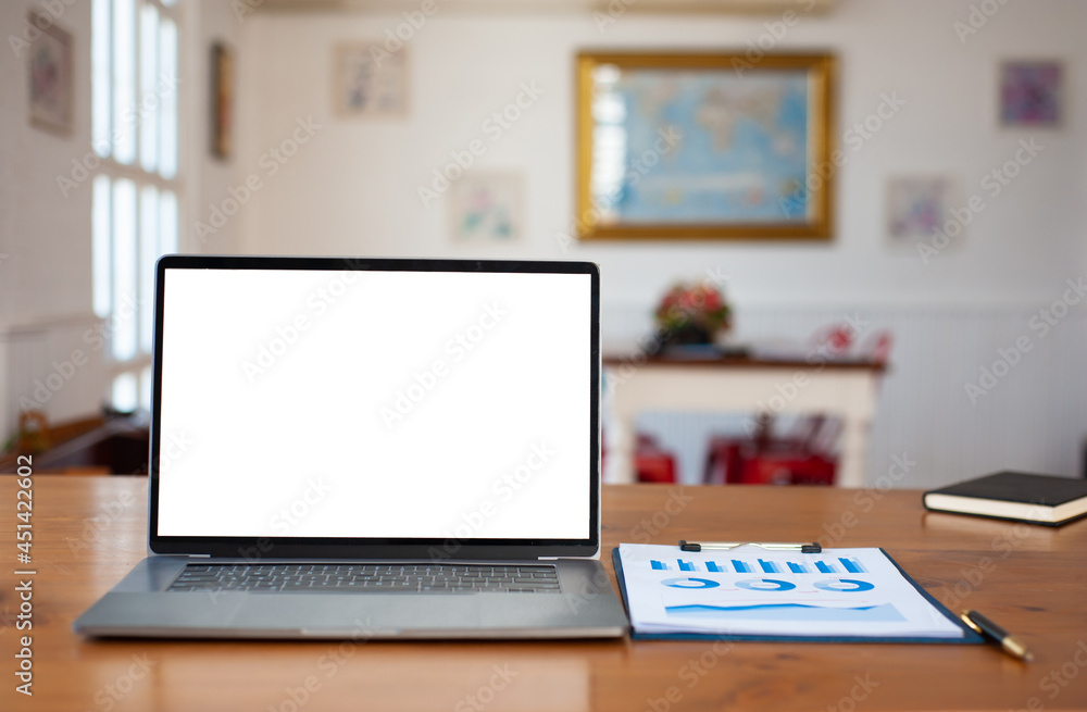 A laptop with an empty screen on an office desk.