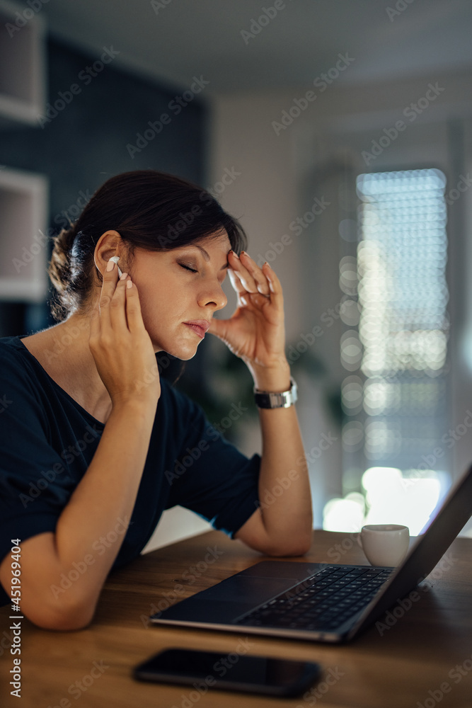 Exhausted businesswoman working late at home.