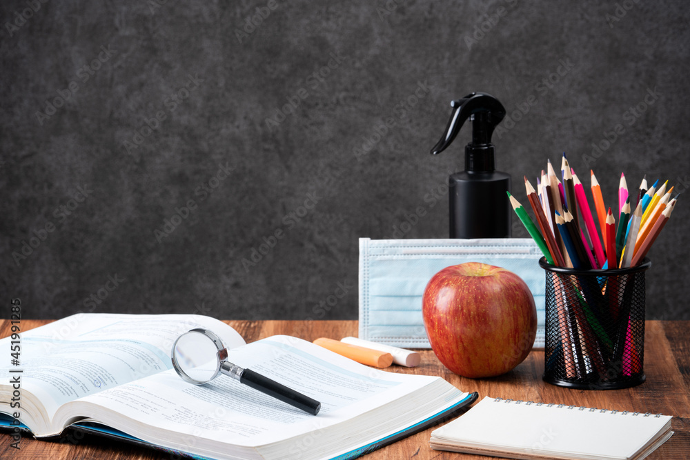 Back to school design concept with stationery over wooden table background.