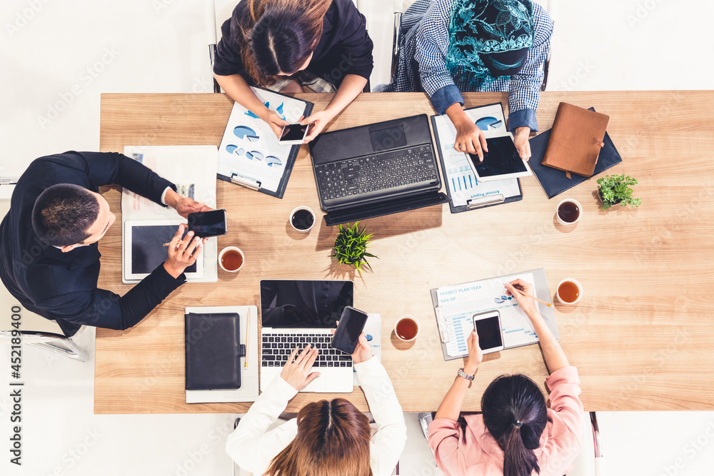 Top view of businessman executive in group meeting with other businessmen and businesswomen in moder