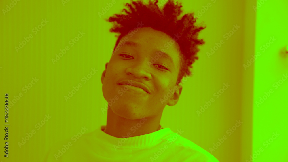 Duotone or half tone portrait of young african american man in studio looking at camera