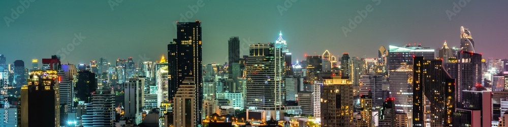 Night cityscape and high-rise buildings in metropolis city center . Downtown business district in pa