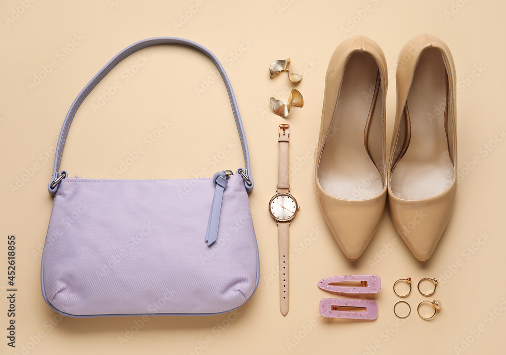 Composition with trendy handbag and accessories on color background