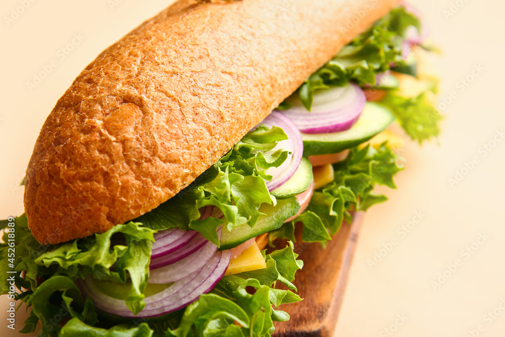 Board with tasty sandwich on color background, closeup