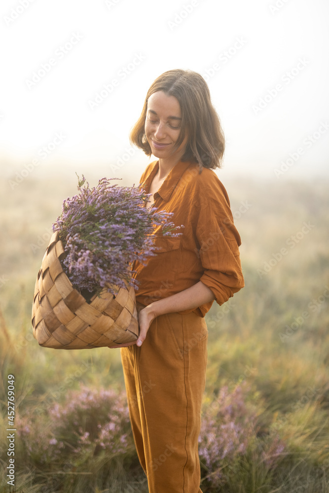 一个可爱的女人的肖像，带着刚摘下的石南花花束，穿着雾蒙蒙的衣服在山上