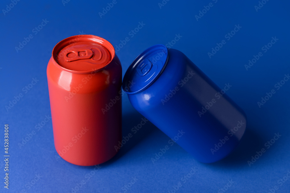 Cans of soda on color background