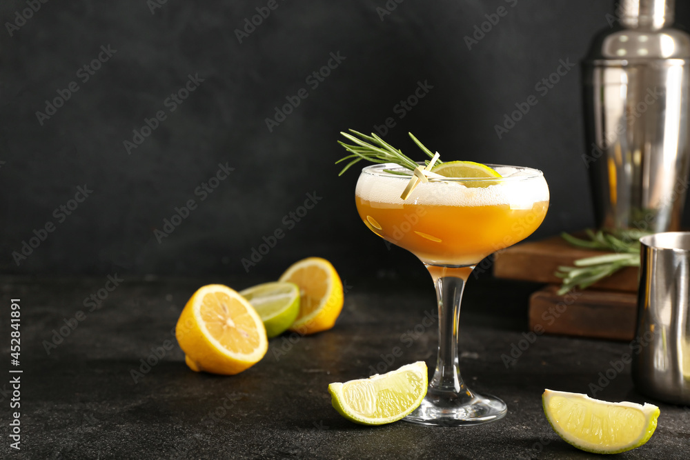 Glass of tasty whiskey sour cocktail on dark background