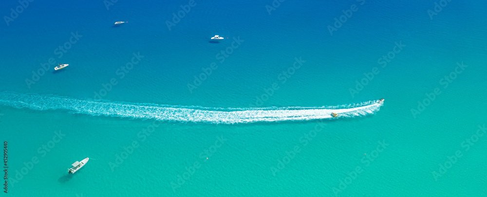 Speed boat with slider leave trail on water, sea panorama from above