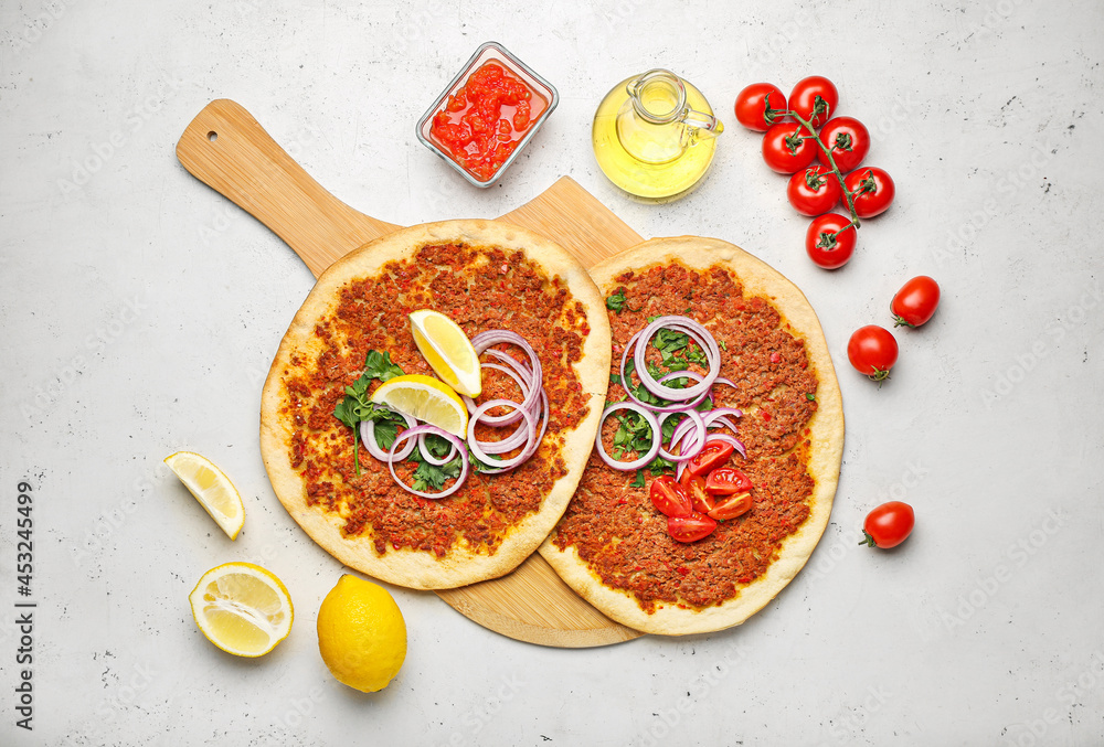 Board with delicious Turkish pizza on light background