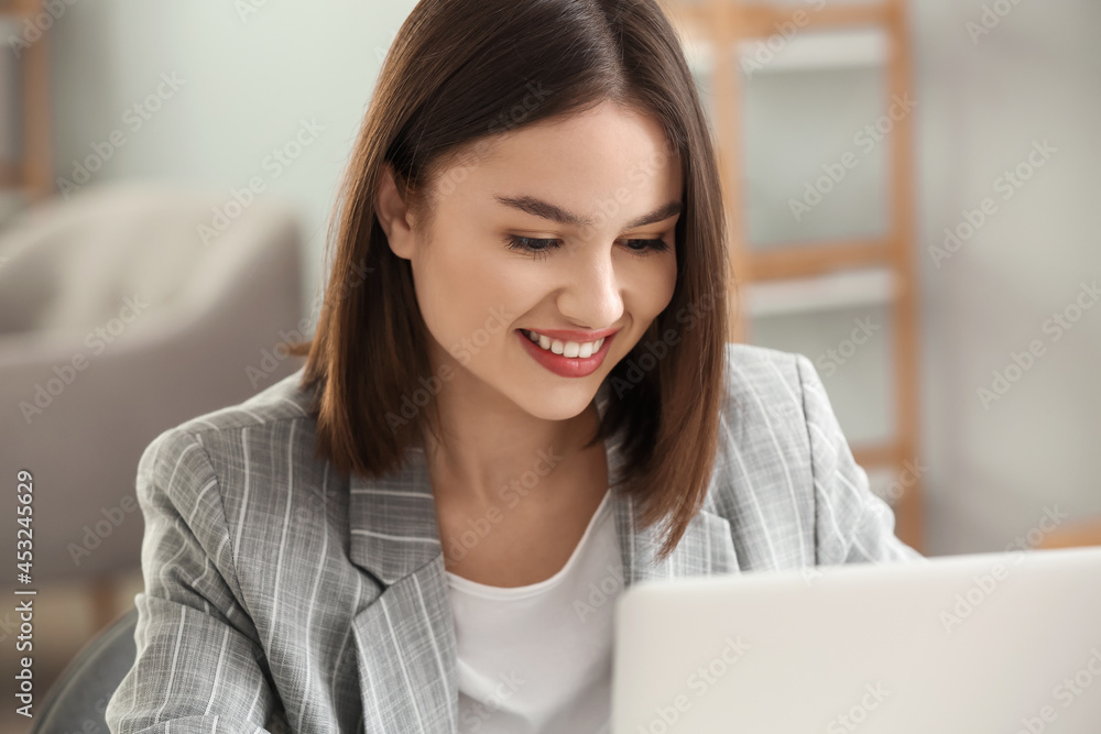 Young woman with laptop at home