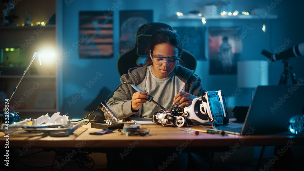 Young Teenage Multiethnic Schoolgirl is Studying Electronics and Soldering Wires and Circuit Boards 