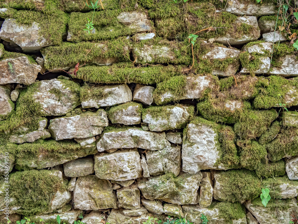 Ancient wall masonry from chipped granite blocks. Wall stone pattern.