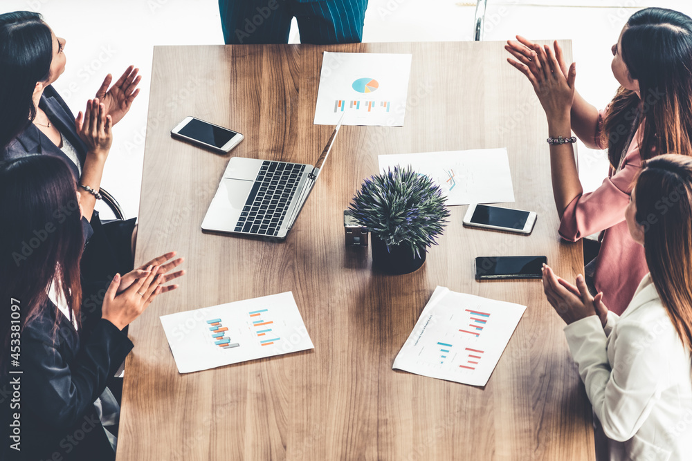 Businesswoman in group meeting discussion with other businesswomen colleagues in modern workplace of