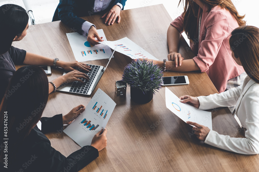 Businesswoman in group meeting discussion with other businesswomen colleagues in modern workplace of